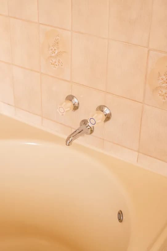 The spa bath in the King Spa Room, cream tiles and chrome taps.