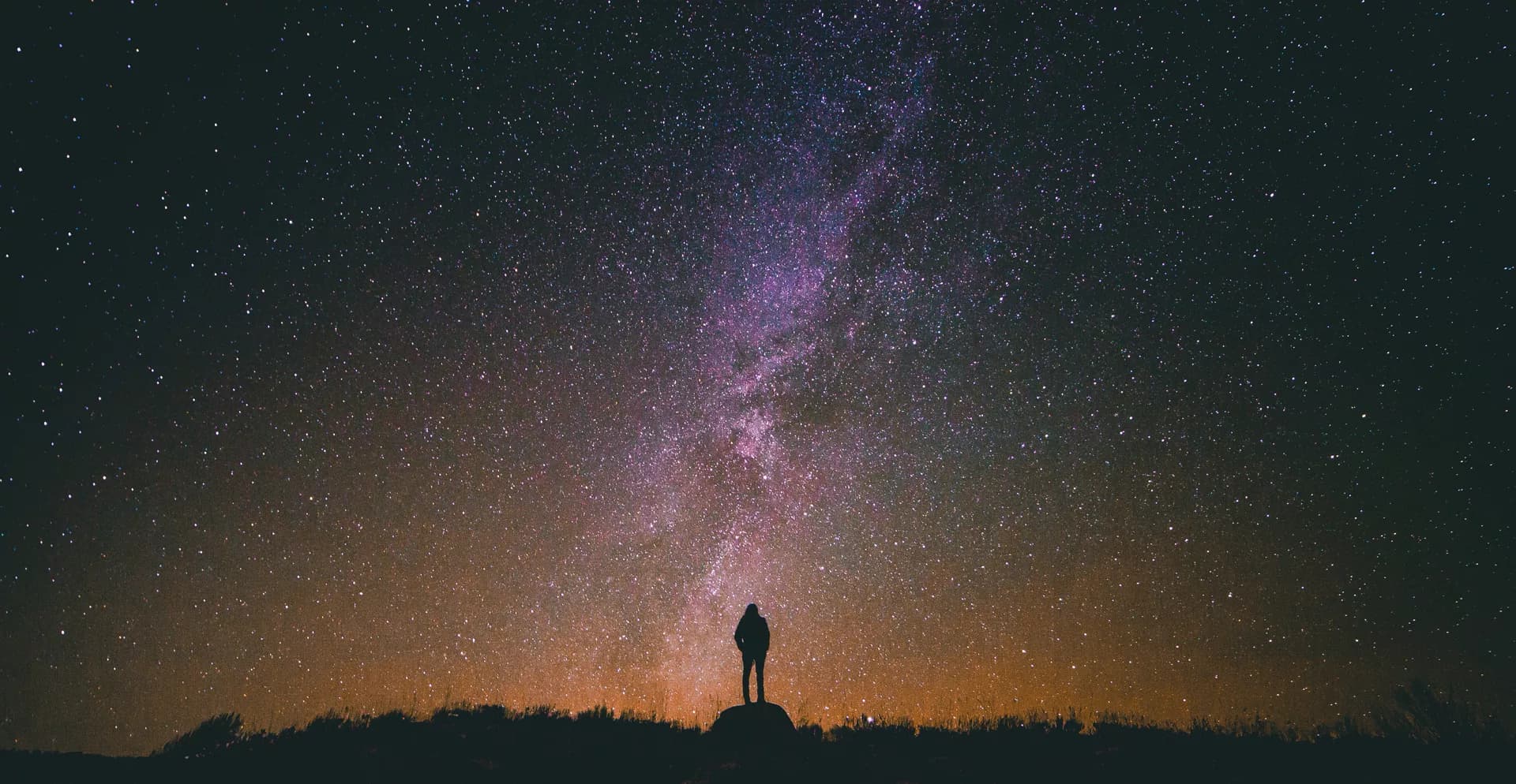 The Milky Way over a dark horizon.